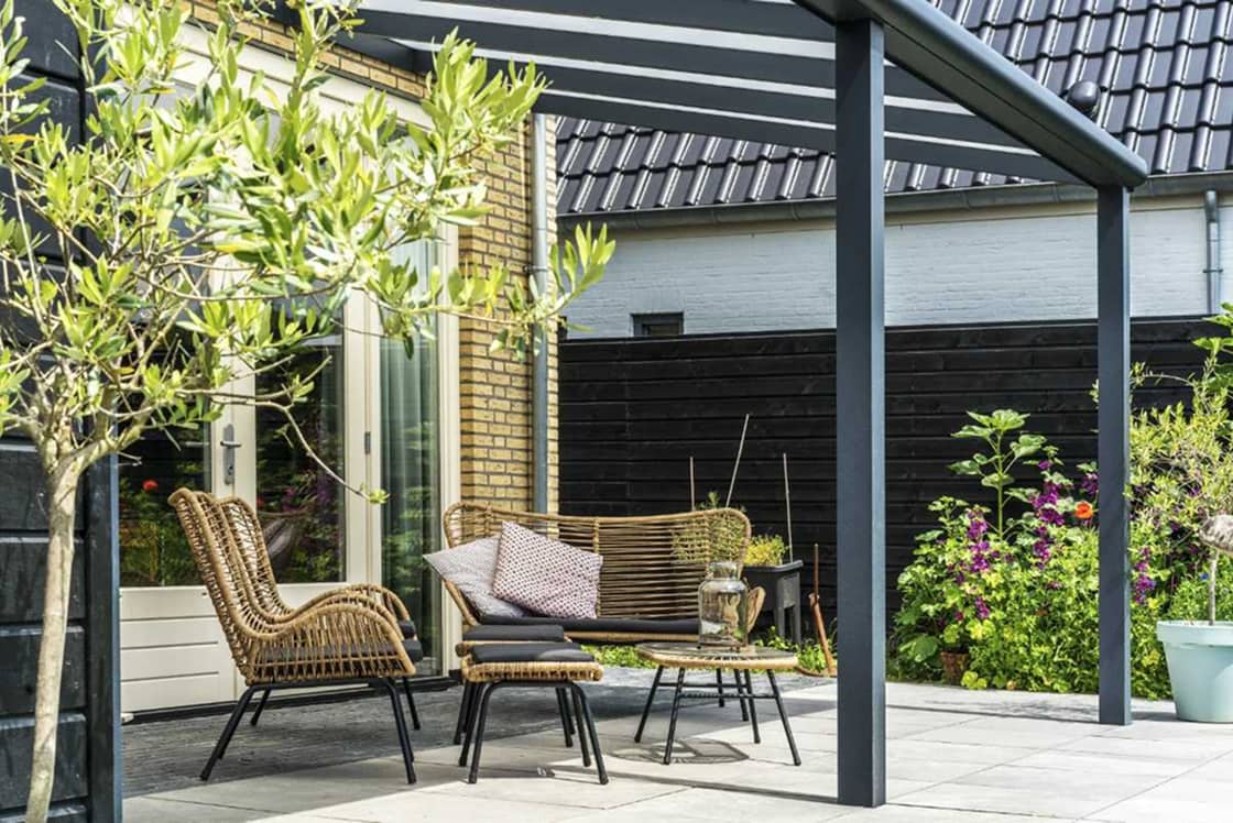 aluminium-veranda-and-patio Aluminium veranda and patio seating area installation by Suffolk Outdoor Living in a landscaped garden.