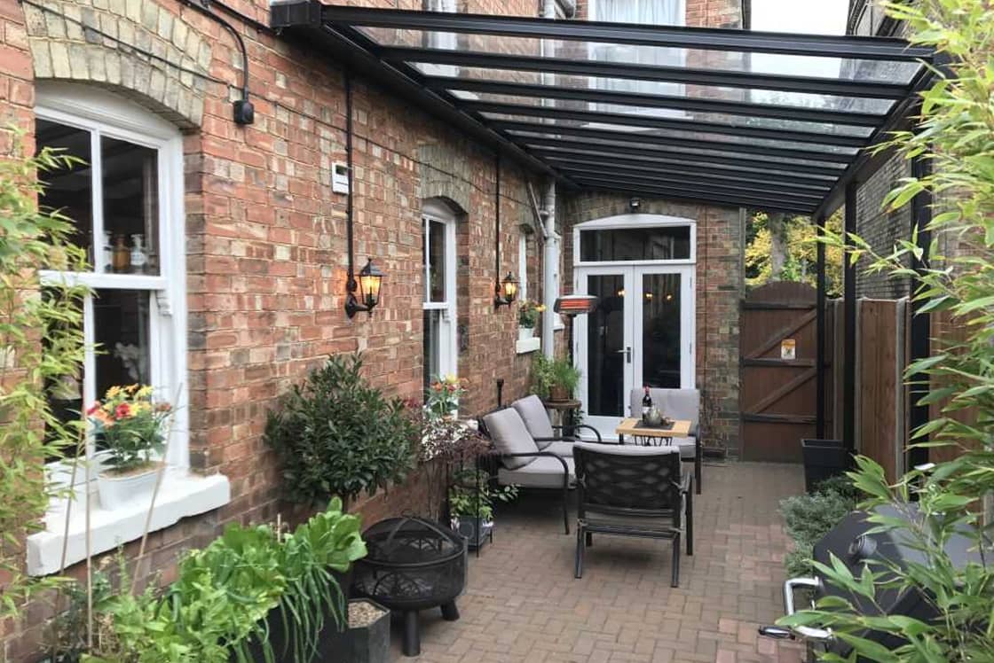black-aluminium-veranda-with-glass-roof Black aluminium veranda with glass roof designed and installed by Suffolk Outdoor Living.